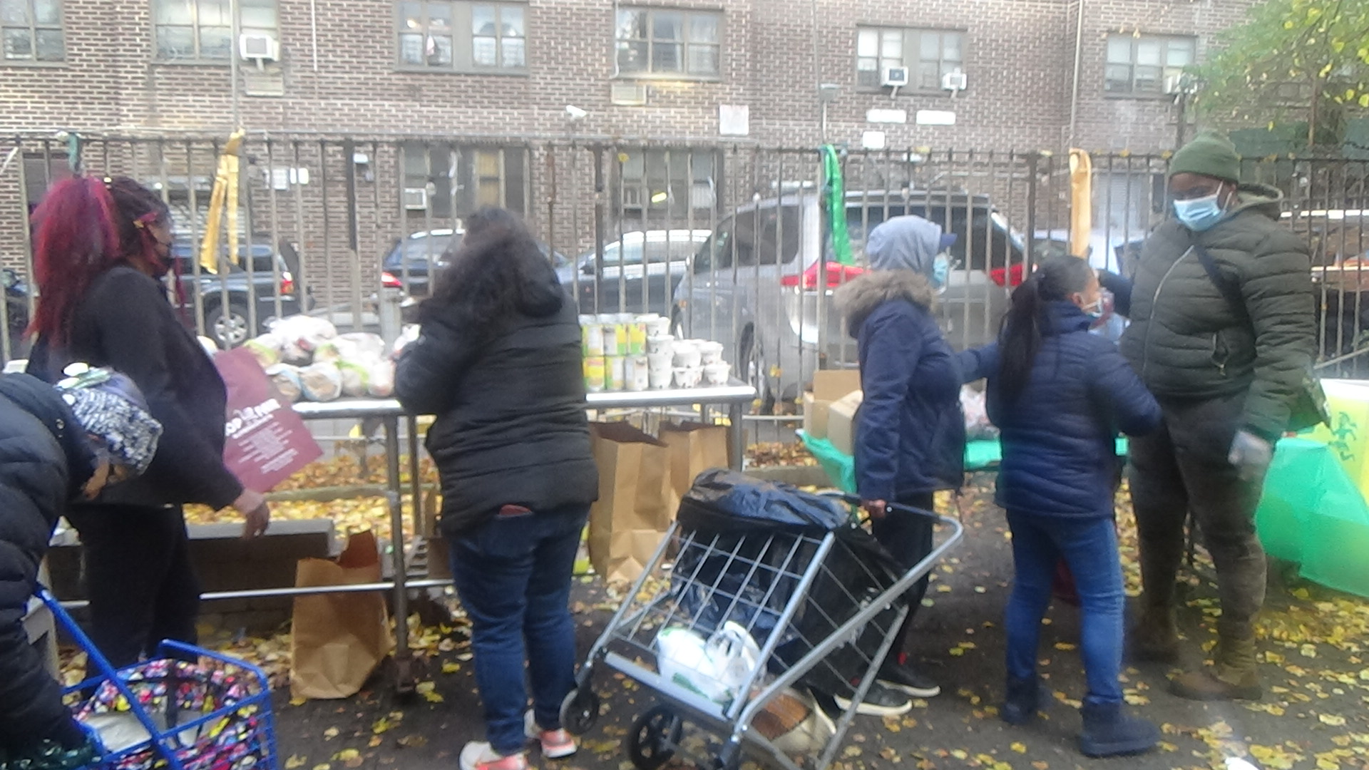 Families collecting items outdoors during a winter distribution event